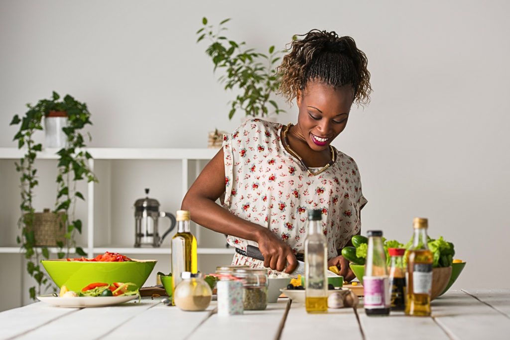 Woman making a salad after nutrition guidance